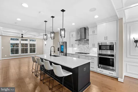 a kitchen with a refrigerator and a stove top oven
