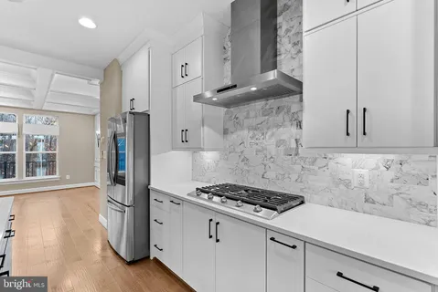 a view of cabinets a oven and a stove in a kitchen