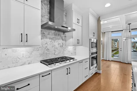 a bathroom with a sink vanity mirror and toilet