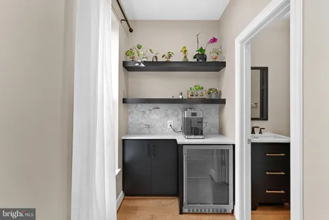 a bedroom with a bed painting and a large window