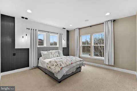 a bedroom with a large bed and a chandelier