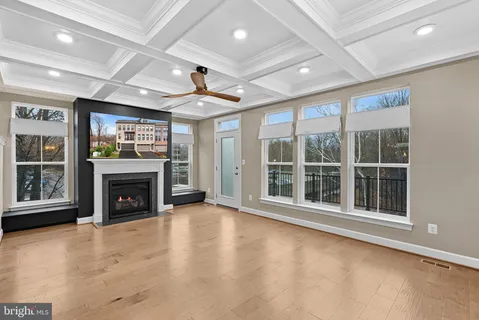 a view of an empty room with a fireplace and a window