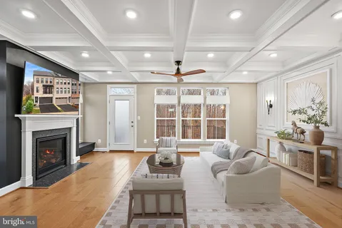 a living room with furniture a large window and a fireplace