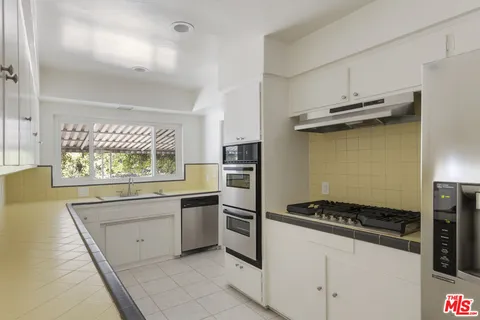 a kitchen with a stove and a refrigerator