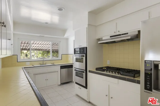 a kitchen with a stove and a refrigerator