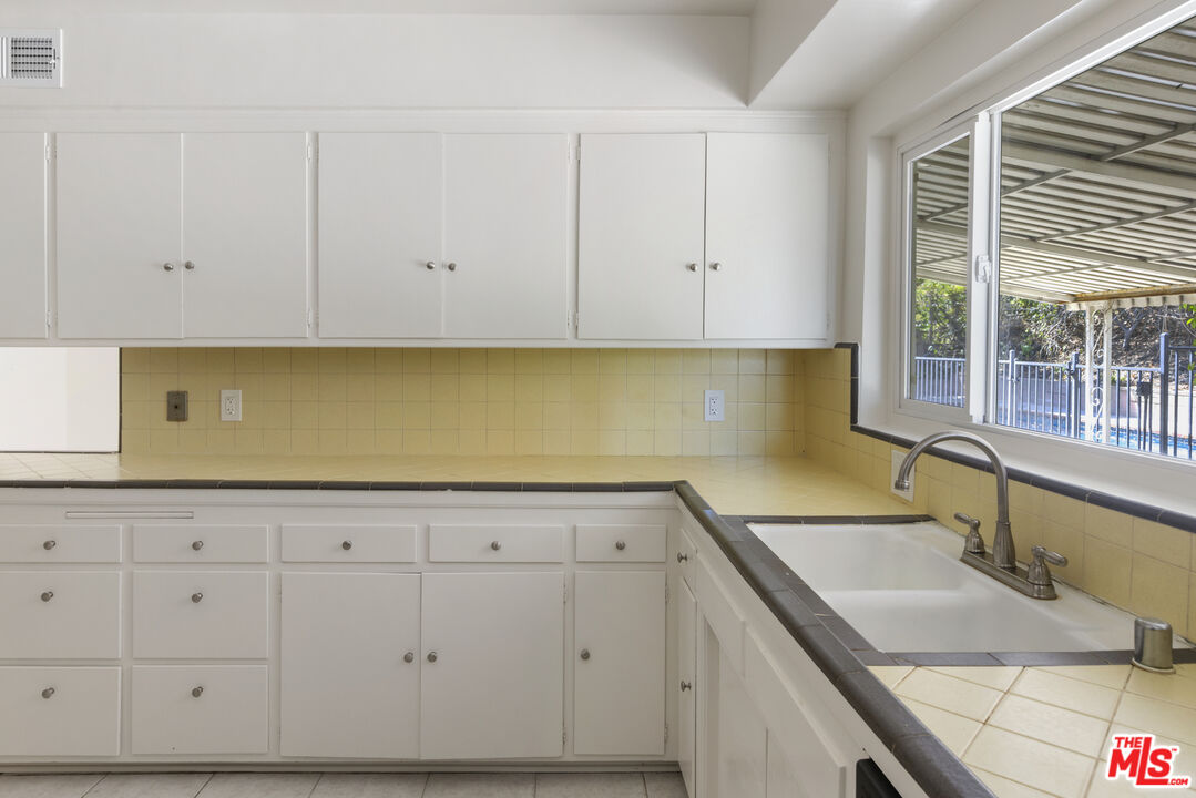 15508 Royal Ridge Road Sherman Oaks, CA 91403 - Photo 13 of 39 a kitchen with a sink cabinets and window
