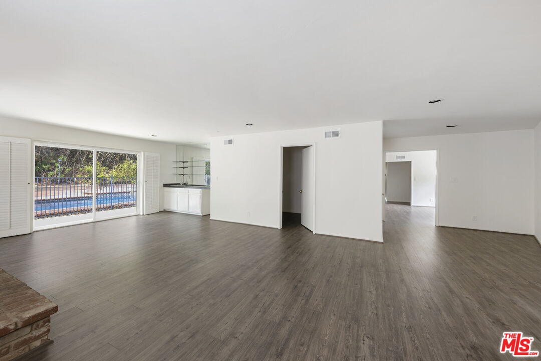 15508 Royal Ridge Road Sherman Oaks, CA 91403 - Photo 17 of 39 a view of empty room with wooden floor and fireplace