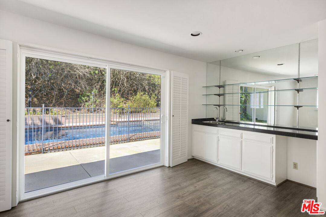 15508 Royal Ridge Road Sherman Oaks, CA 91403 - Photo 19 of 39 a kitchen with stainless steel appliances granite countertop a stove and a sink