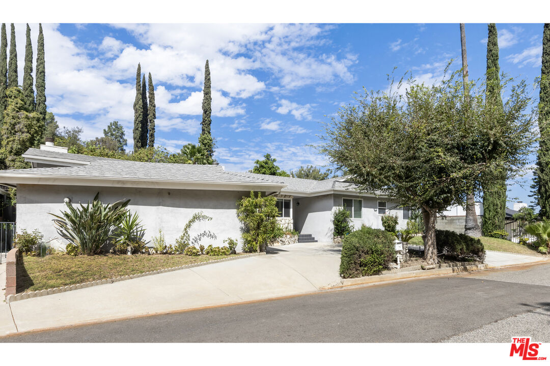 15508 Royal Ridge Road Sherman Oaks, CA 91403 - Photo 4 of 39 front view of a house with a yard