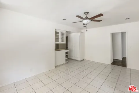 a view of a livingroom with a ceiling fan and window