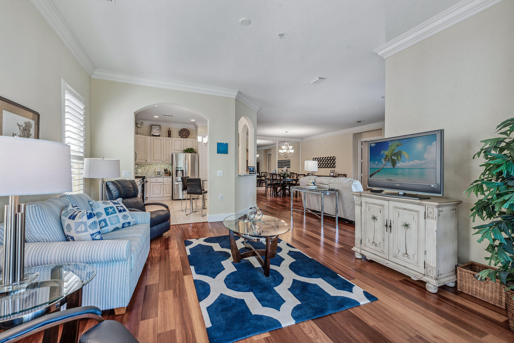 3189 Aviamar Circle, Unit 202 Naples, FL 34114 - Photo 11 of 50 a living room with furniture and a flat screen tv