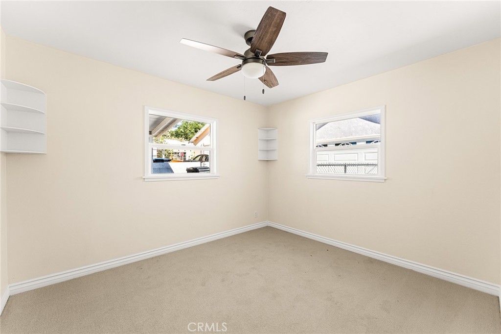 1253 Cottonwood Road Banning, CA 92220 - Photo 18 of 22 an empty room with a window and a ceiling fan