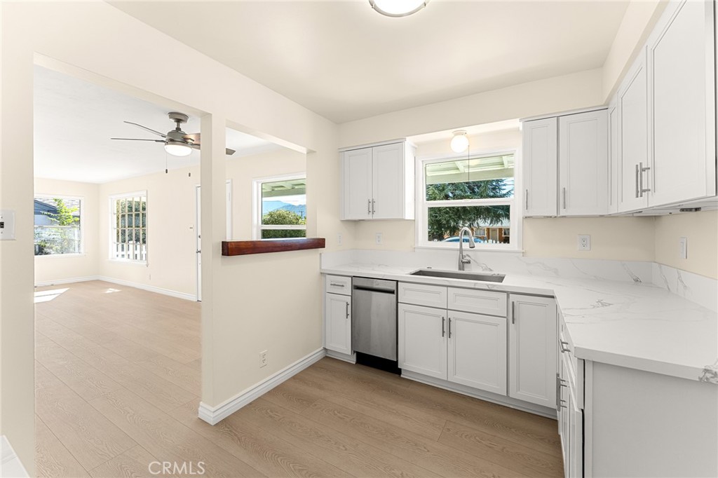 1253 Cottonwood Road Banning, CA 92220 - Photo 20 of 22 a kitchen with a sink stove and cabinets