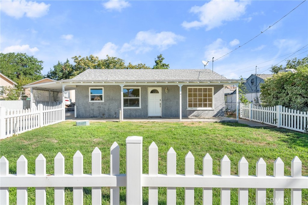 1253 Cottonwood Road Banning, CA 92220 - Photo 2 of 22 a front view of a house with a garden