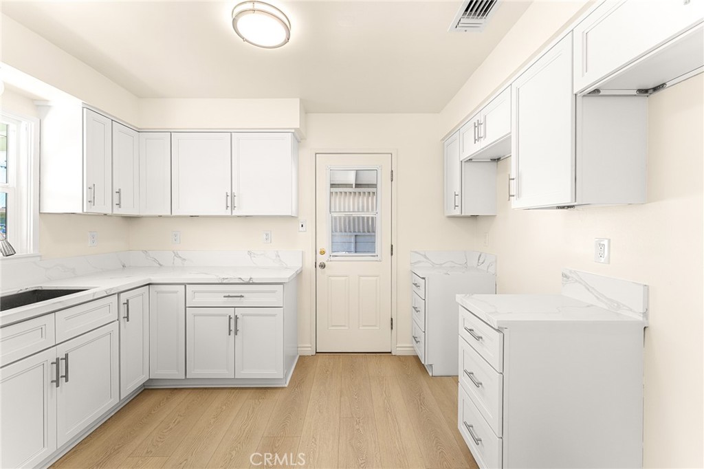 1253 Cottonwood Road Banning, CA 92220 - Photo 21 of 22 a kitchen with white cabinets and sink