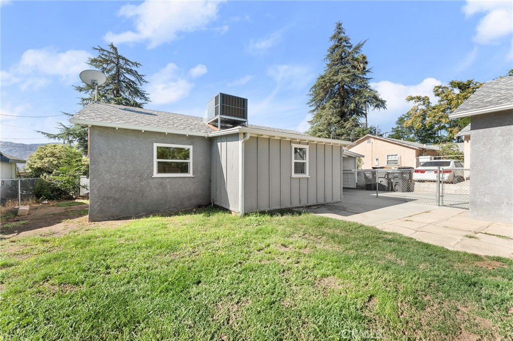 1253 Cottonwood Road Banning, CA 92220 - Photo 8 of 22 a white house that has a tree in front of it