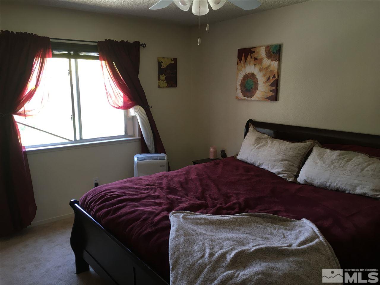 6501 Flower Street Reno, NV 89506 - Photo 11 of 19 a bedroom with a bed and a window