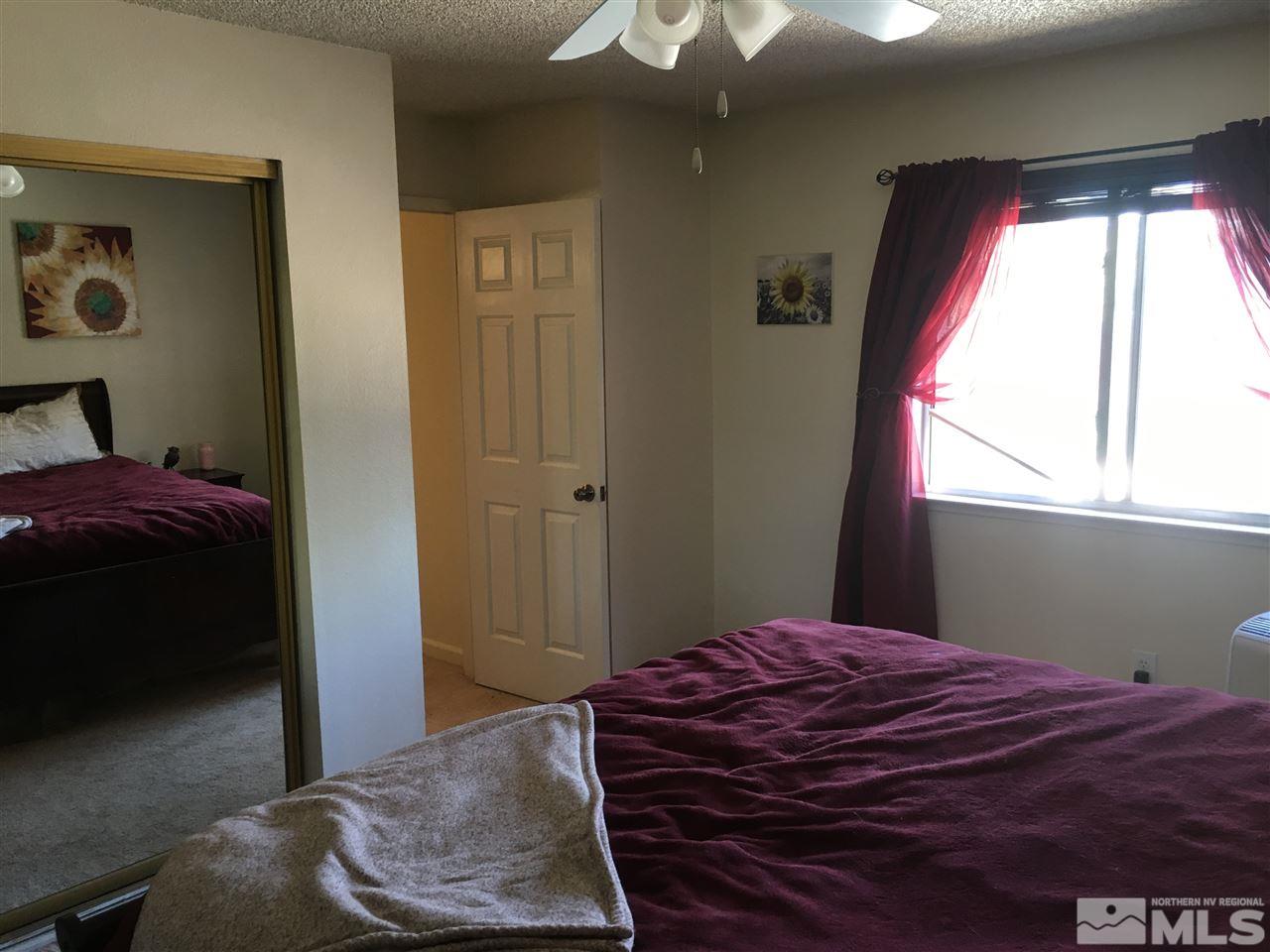 6501 Flower Street Reno, NV 89506 - Photo 12 of 19 a bedroom with a bed and a window