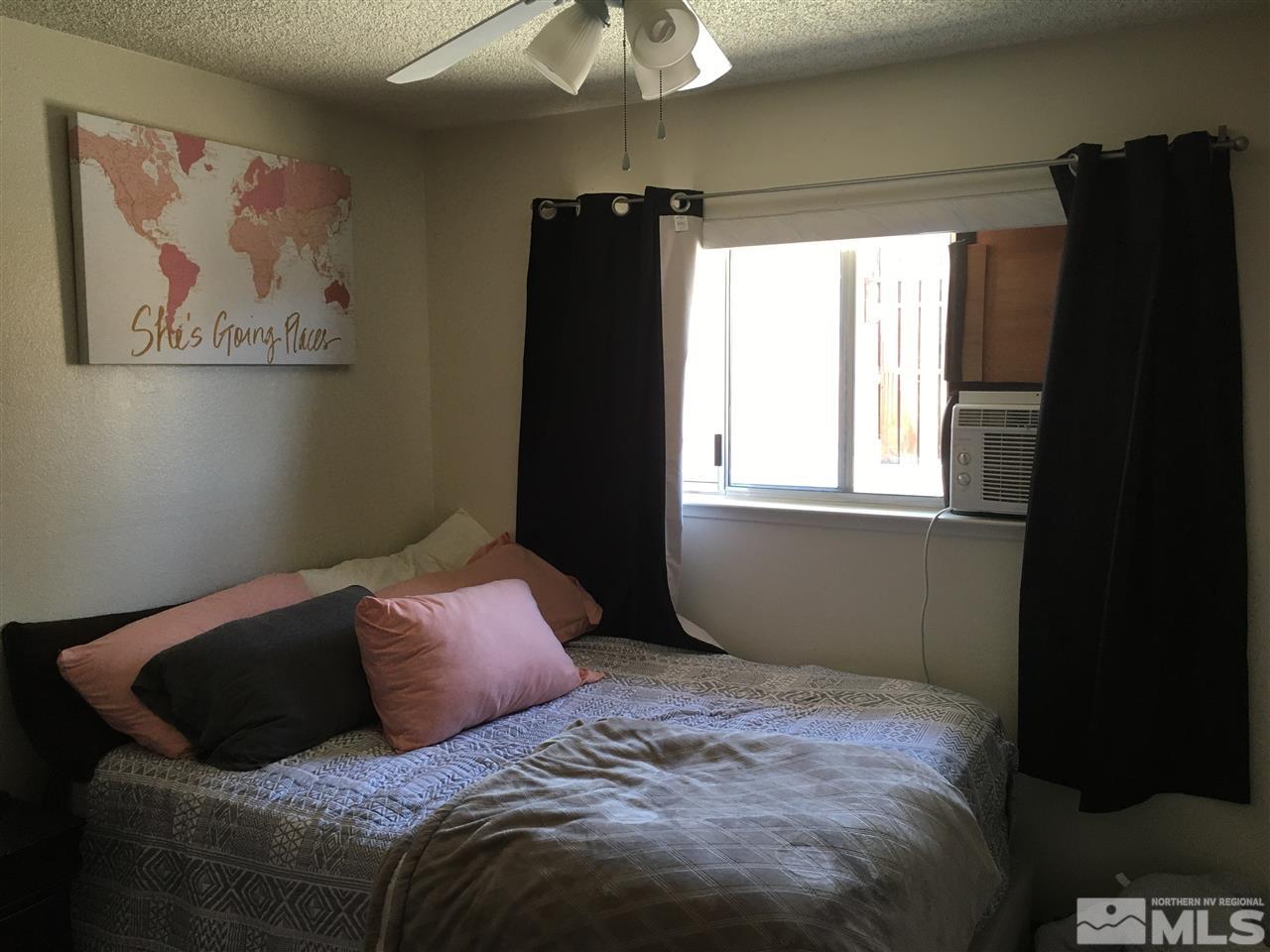6501 Flower Street Reno, NV 89506 - Photo 13 of 19 a bedroom with a bed and a chandelier