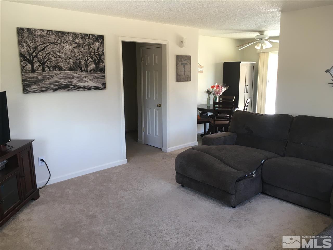 6501 Flower Street Reno, NV 89506 - Photo 2 of 19 a living room with furniture and a flat screen tv