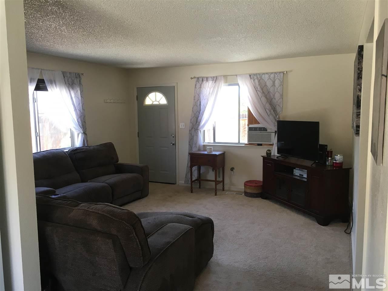 6501 Flower Street Reno, NV 89506 - Photo 4 of 19 a living room with furniture and a flat screen tv