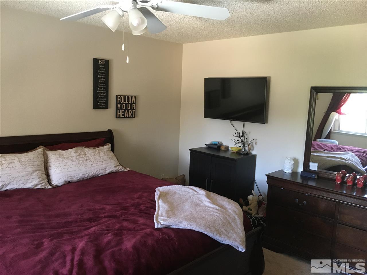6501 Flower Street Reno, NV 89506 - Photo 10 of 19 a bedroom with a bed and a flat screen tv