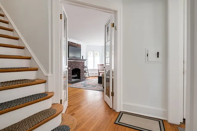 a view of a livingroom with wooden floor and staircase