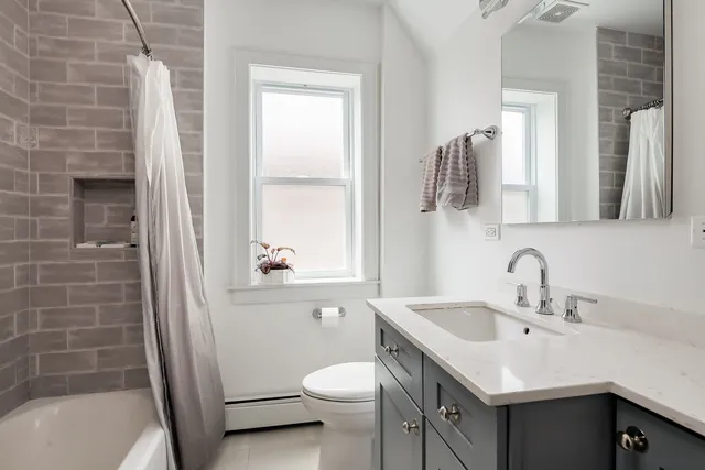 a bathroom with a sink toilet and shower