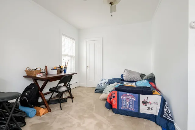 a bedroom with furniture and a window