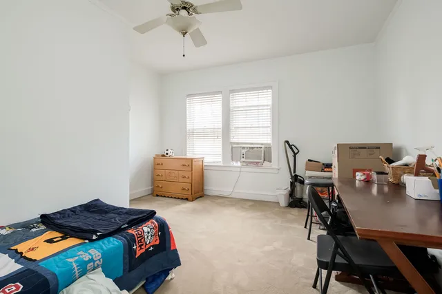 a bedroom with a bed and a dresser