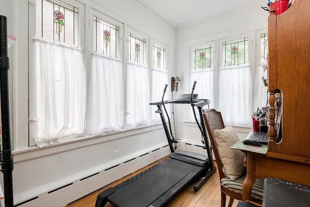 a view of a workspace with furniture and a window