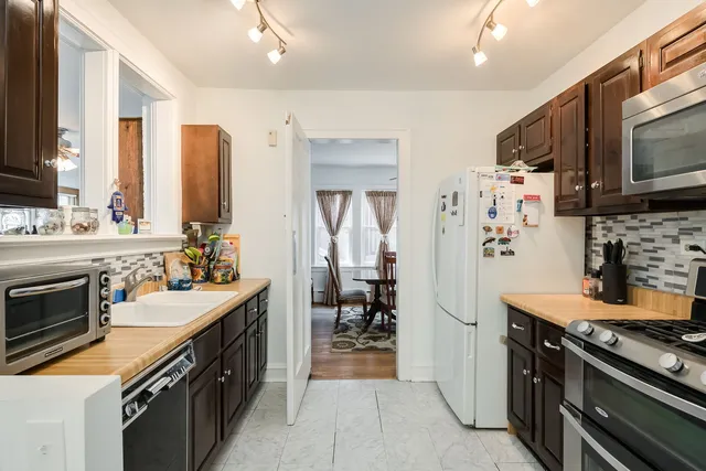 a kitchen with stainless steel appliances a stove sink and refrigerator