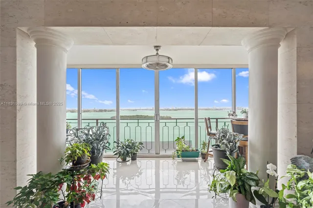 a vase of flowers sitting on a table in front of a window