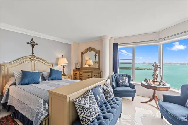 a living room with furniture and a floor to ceiling window