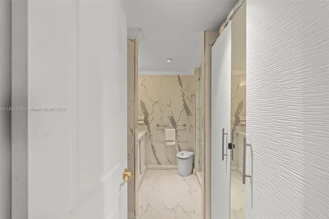 a white toilet sitting next to a bathroom sink