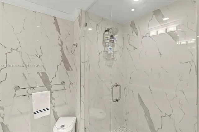 a view of a hallway with wooden floor and closet