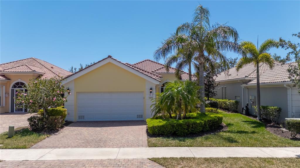 13415 Coluccio Street Venice, FL 34293 - Photo 1 of 1 a front view of a house with a garden