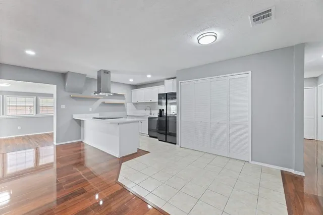 a dining room with furniture a rug and wooden floor