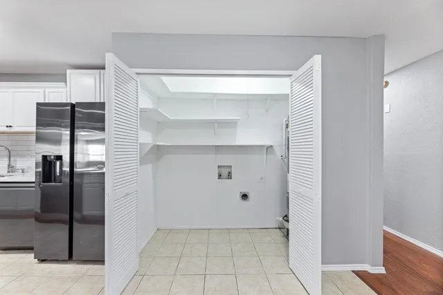 a view of empty room with wooden floor and window