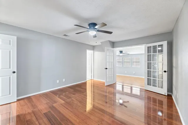 a view of a refrigerator in kitchen and an empty room