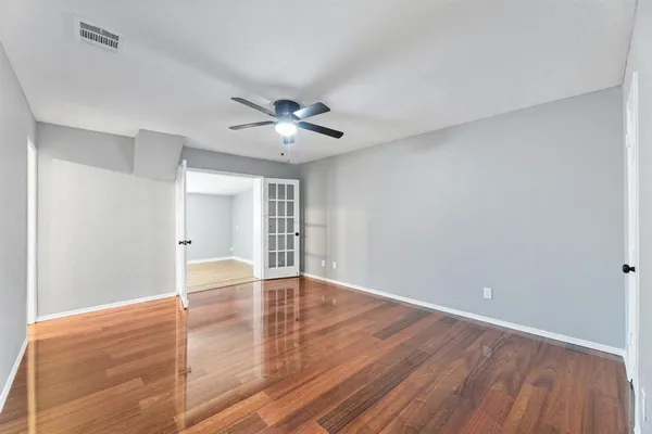 a bedroom with a bed chandelier and a window