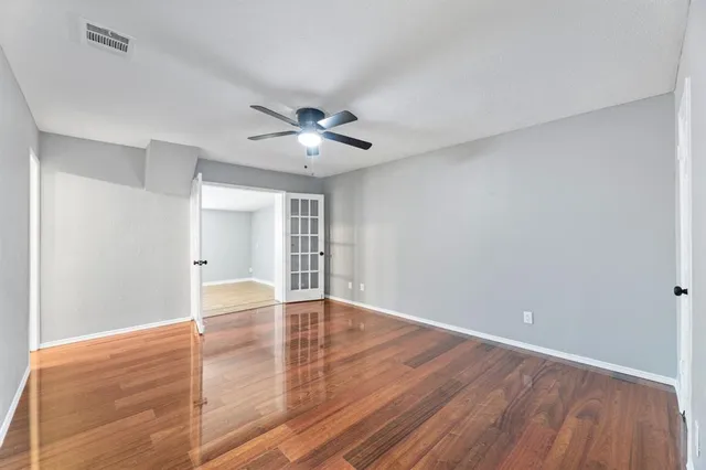 a bedroom with a bed chandelier and a window