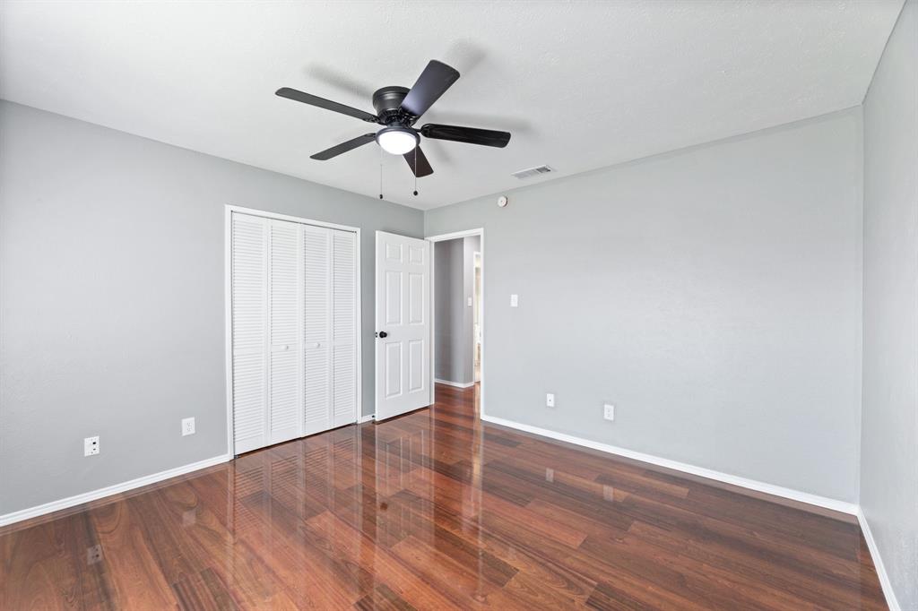 100 West Way Drive Allen, TX 75002 - Photo 20 of 31 2nd bedroom featuring dark wood-type flooring, a ceiling fan, and a closet