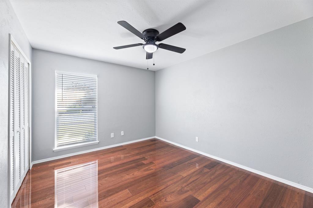 100 West Way Drive Allen, TX 75002 - Photo 24 of 31 Another view of 3rd bedroom with dark wood finished floors, ceiling fan, and a closet