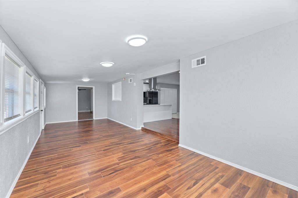 100 West Way Drive Allen, TX 75002 - Photo 6 of 31 Bonus room featuring dark wood-type flooring & baseboards. Playroom, sitting area, study, a great addition to the home! Just off family room and kitchen. Door leads to back yard.