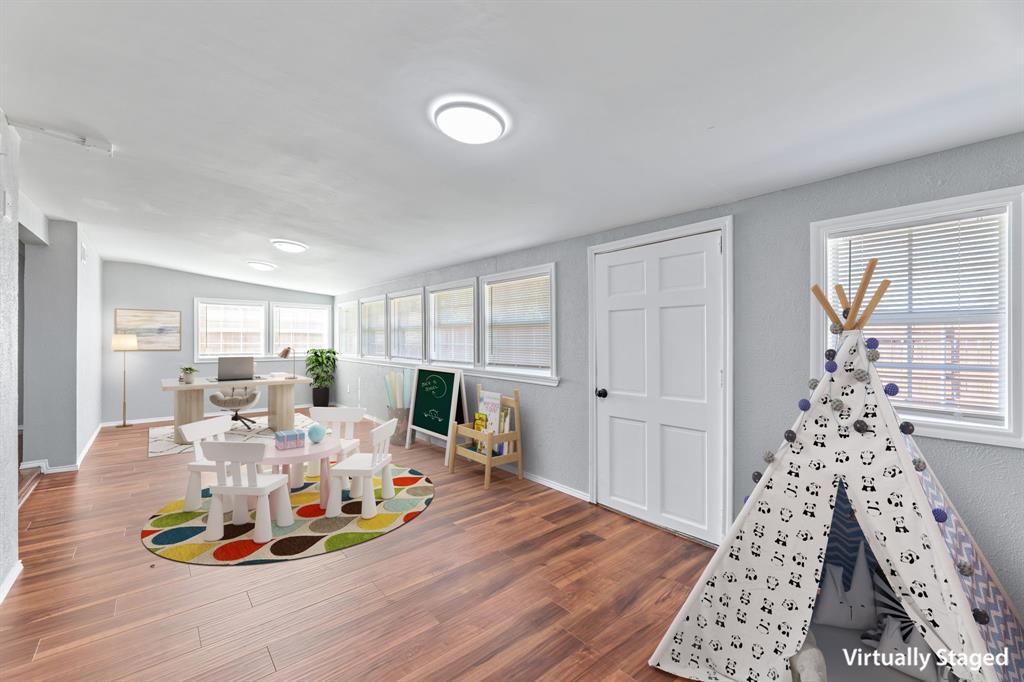 100 West Way Drive Allen, TX 75002 - Photo 7 of 31 Virtual staged Bonus, Rec room with wood finished floors, plenty of natural light, and lofted ceiling