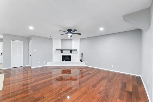 a view of a livingroom with wooden floor and staircase