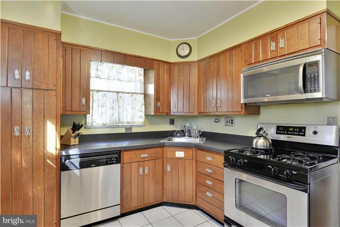 606 Forest Glen Road Silver Spring, MD 20901 - Photo 5 of 25 a kitchen with stainless steel appliances granite countertop a stove and a microwave