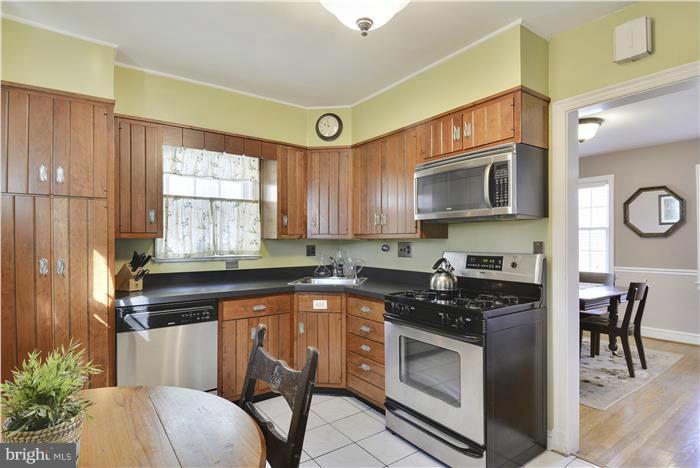 606 Forest Glen Road Silver Spring, MD 20901 - Photo 6 of 25 a kitchen with granite countertop a stove a sink and a microwave