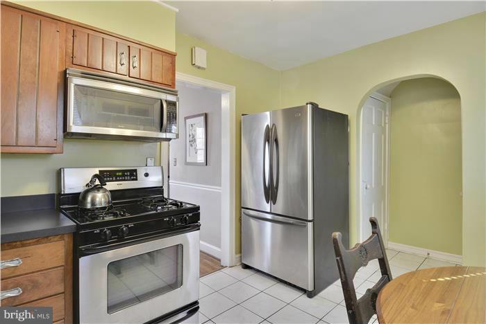 606 Forest Glen Road Silver Spring, MD 20901 - Photo 7 of 25 a kitchen with stainless steel appliances a stove microwave and a refrigerator